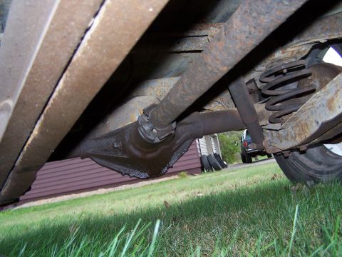 1969 Chevrolet C/K Pickup - The underside of a vehicle is shown, focusing on the drivetrain and suspension components.