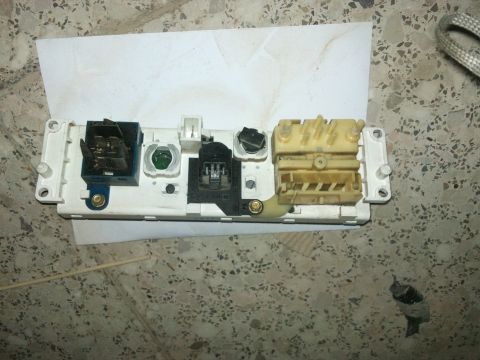 1998 Ford Crown Victoria - This electrical assembly features various connectors and switches, likely from a vehicle's dashboard or control panel.