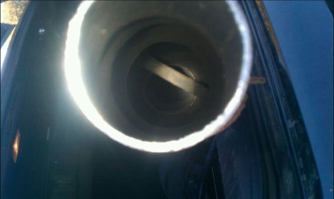 1986 Ford Bronco - Close-up view inside an exhaust pipe, with a SuperMotors watermark visible at the bottom right.