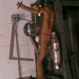1986 Ford Bronco - An exhaust pipe assembly, including a muffler and catalytic converter, is shown mounted vertically.