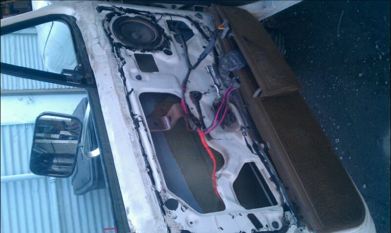 1986 Ford Bronco interior door panel removed, showing speaker and wiring