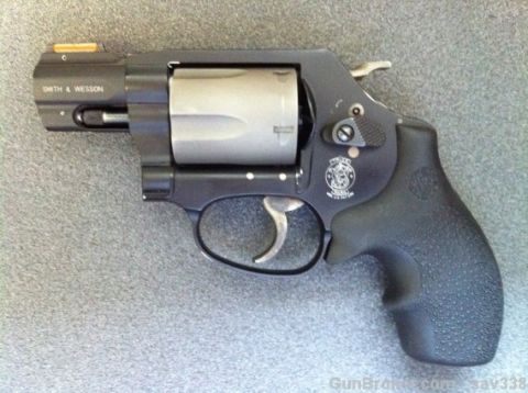 2000 Chevrolet Tahoe - A Smith & Wesson revolver is shown with its characteristic cylinder and textured grip.