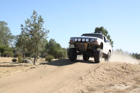 1996 Ford Bronco - This 1996 Ford Bronco is shown off-road, modified for rough terrain with auxiliary lights and a lifted suspension.