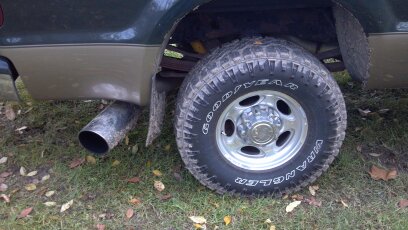 1993 Ford F-150 - Rear wheel and exhaust pipe of a 1993 Ford F-150 truck.