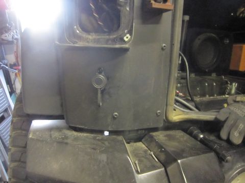 2008 Jeep Wrangler - The rear of a vehicle is shown, a key lock mechanism and exposed interior wiring, with a subwoofer visible in the background.