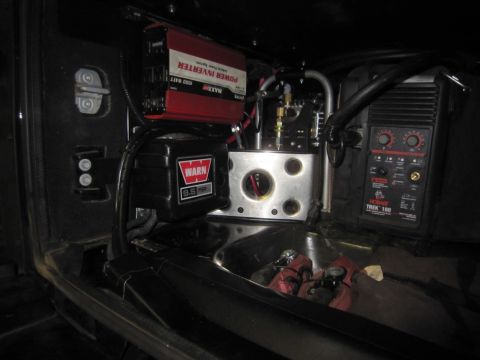 2008 Jeep Wrangler - Vehicle interior with aftermarket winch, power inverter, and welder installed.