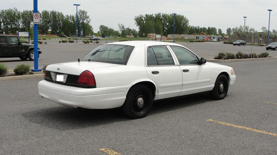 White 2006 Ford Crown Victoria, rear three-quarter view