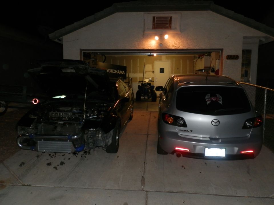 Black car with hood open, intercooler visible