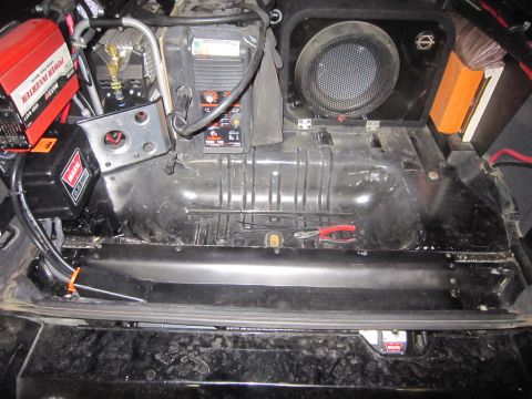 2008 Jeep Wrangler - Aftermarket winch, power inverter, and speaker installed in the rear of a vehicle.
