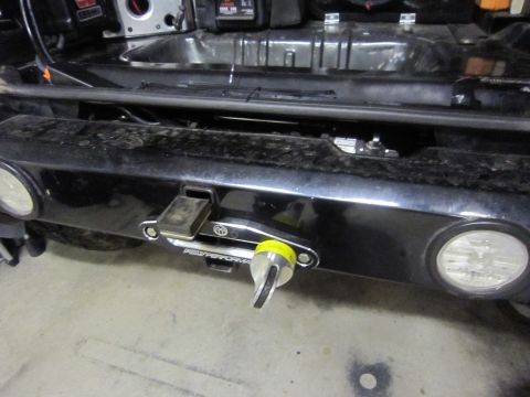 2008 Jeep Wrangler - Close-up of a vehicle's rear bumper, showing a winch and a tow hook assembly.
