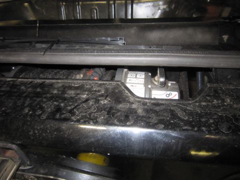 2008 Jeep Wrangler - A winch is visible behind a dusty black bumper, with various warning symbols on its casing.