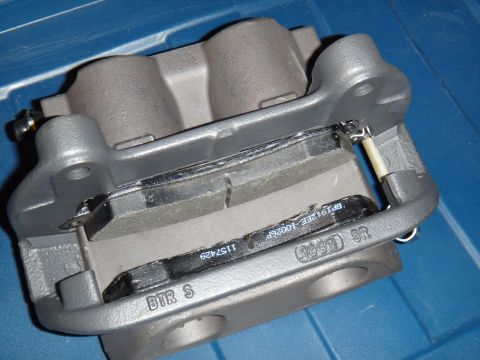 2003 Ford Taurus - A close-up view of a brake caliper and pads, with part numbers visible on the pads.