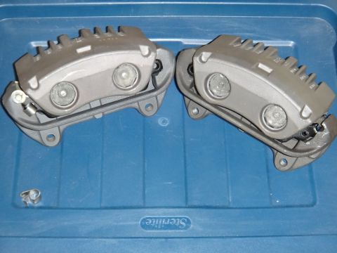 2003 Ford Taurus - Pair of brake calipers shown against a blue storage bin.