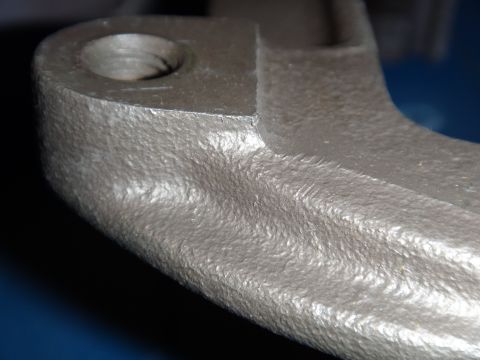2003 Ford Taurus - Cast metal part with a threaded hole, likely an automotive component.