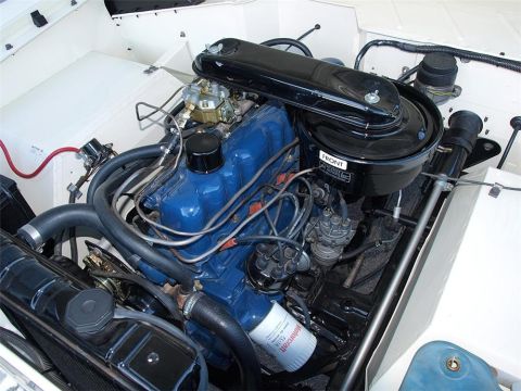1990 Ford Bronco - The engine bay of a vehicle, showing the V8 engine and associated components.