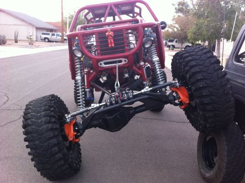 Suzuki Samurai - Custom off-road buggy front axle assembly with heavy-duty suspension and large tires.