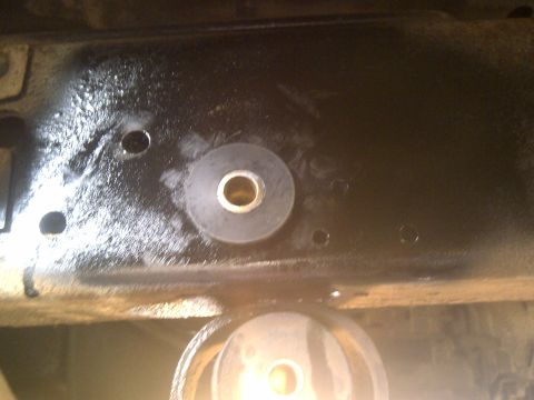 1979 Ford E250 - A close-up view of a vehicle's undercarriage, focusing on a rubber bushing attached to the frame.