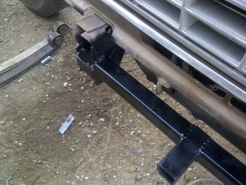 1979 Ford E250 - Close-up of the front grille and bumper of a 1979 Ford E250 van, showing suspension components.