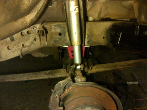 1979 Ford E250 - Undercarriage view shows the front suspension system, including the shock absorber and brake rotor.