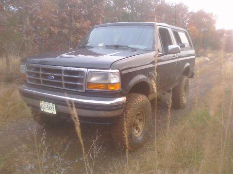 1995 Ford Bronco - This 1995 Ford Bronco is shown in a three-quarter front view, a dark paint color and lifted suspension with off-road tires.