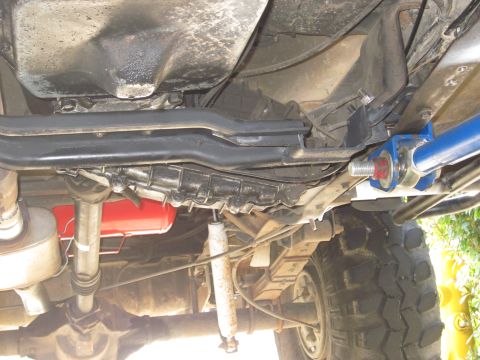 1985 Ford Bronco - This photo shows the undercarriage of a vehicle, focusing on the transmission, driveshaft, and suspension components.
