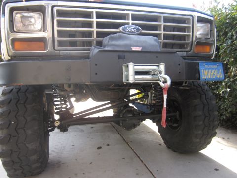 1985 Ford Bronco - This lifted Ford Bronco features a prominent winch and a distinctive grille.