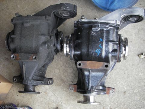 1996 BMW Z3 - Two automotive differentials are shown side-by-side on a concrete surface.