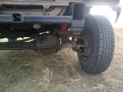 1979 Ford E250 - The rear axle and tire of a 1979 Ford E250 van are visible in this close-up shot.
