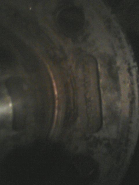1988 Ford Bronco - A close-up view of a vehicle's wheel hub, showing some indistinct markings.