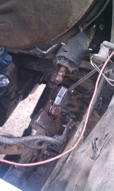 1978 Ford Bronco - Close-up view of a vehicle's steering linkage, showing mechanical parts and electrical wiring.