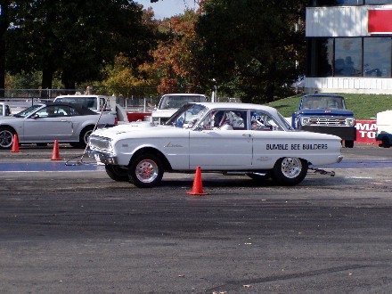 1999 Ford Crown Victoria - White classic drag car with custom lettering on the side, seen at a drag strip event.