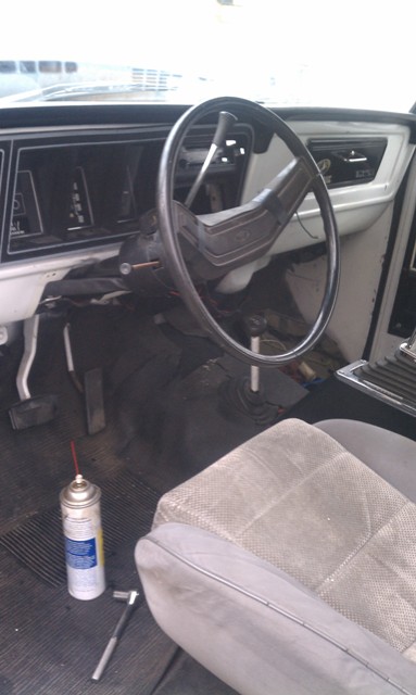 1978 Ford Bronco - The interior of a 1978 Ford Bronco shows its dashboard, steering wheel, and seats, with tools on the floor.