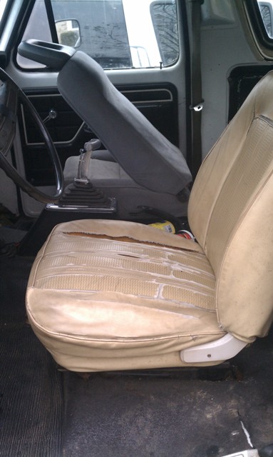 1978 Ford Bronco - The interior shows significant wear on the tan seats and a grey bucket seat, with a manual transmission visible.
