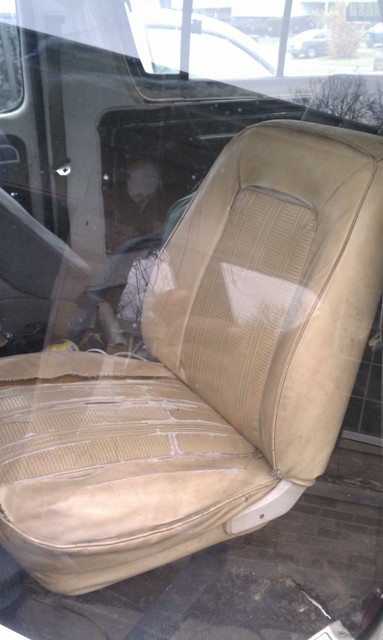1978 Ford Bronco - Interior view of a worn tan fabric seat with visible damage and dirt.