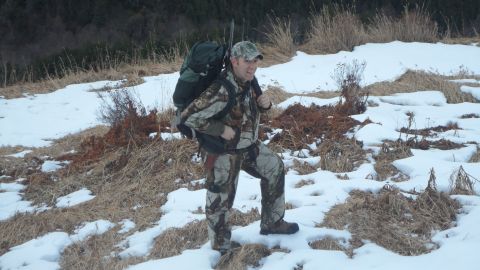 1986 Chevrolet Blazer - A person dressed in camouflage stands in a snowy landscape, blending into the winter environment.