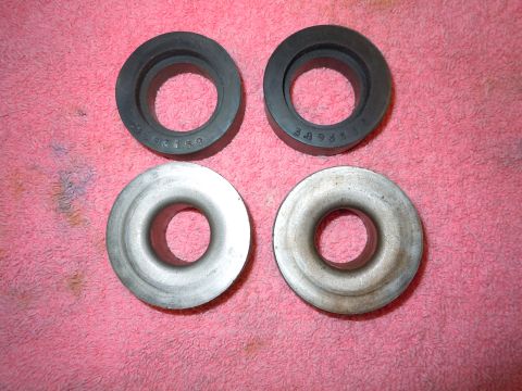 1982 Chevrolet Camaro - Two rubber and two metal rings are laid out on a pink fabric surface.