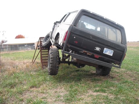 1986 Ford Bronco - This 1986 Ford Bronco is positioned on a metal ramp, its large tires and rear end.