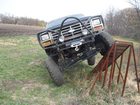 1986 Ford Bronco - This modified Ford Bronco is shown navigating an obstacle course with its front tire on a ramp.