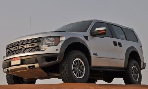 1987 Ford Bronco - Silver SUV with prominent 'FORD' grille, seen in a desert environment.
