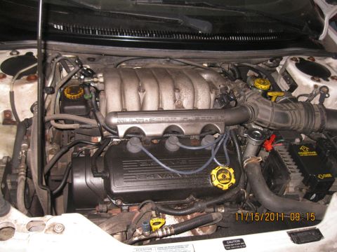 1984 Chevrolet C/K Pickup - Close-up view of a vehicle's engine bay, a 3.4L V6 engine with visible intake manifold and valve cover.