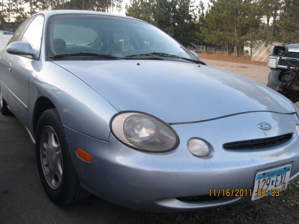 Light blue sedan front view with a Minnesota license plate