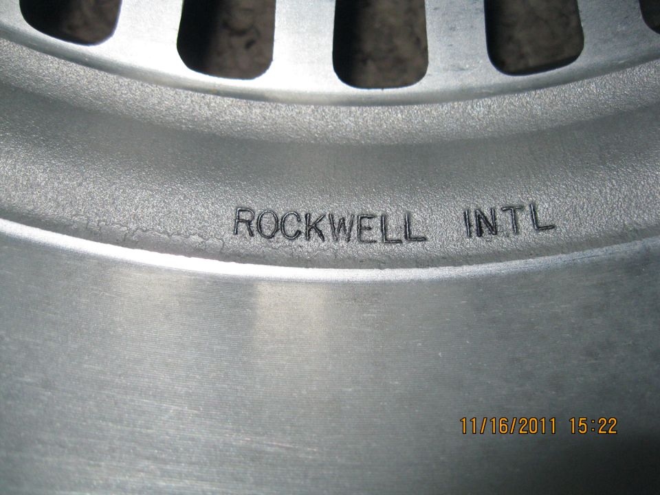 Close-up of a metal wheel rim with 'ROCKWELL INTL' stamped on it