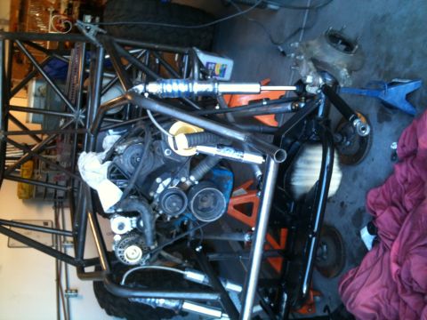 1966 Ford Bronco - Custom off-road buggy chassis undergoing assembly or repair in a garage setting.