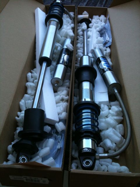 1966 Ford Bronco - New shock absorbers are packed in a box with white foam peanuts for protection.