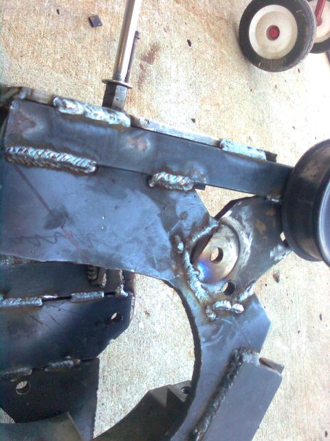 1984 Ford Bronco - Close-up of a custom-welded metal bracket, possibly for a vehicle modification, with Supermotors.net branding visible.