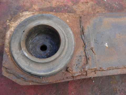 1976 Chevrolet Corvette - A close-up view of a corroded metal component, possibly a suspension part, showing significant rust and wear.