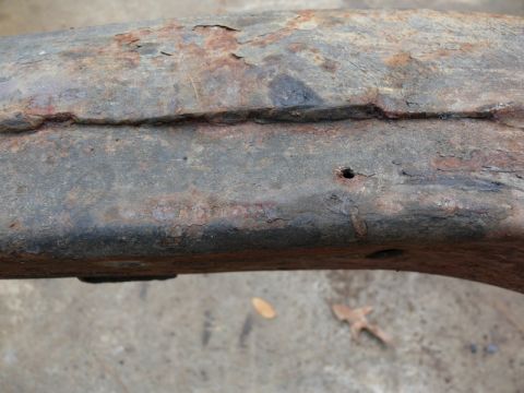 1976 Chevrolet Corvette - This heavily corroded metal component shows significant rust and a small perforation.