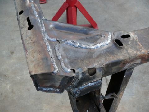 1976 Chevrolet Corvette - Close-up of a heavily welded car frame, likely undergoing repair or modification.