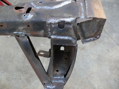 1976 Chevrolet Corvette - Close-up of a heavily modified and welded car frame section, showing structural repairs.