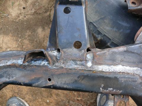 1976 Chevrolet Corvette - This is a close-up view of a welded metal frame part, showing signs of rust and repair.